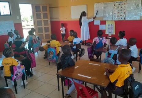 School classroom with children and Sister at whiteboard