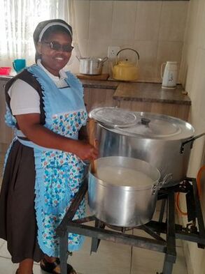 Sister preparing food in large pans