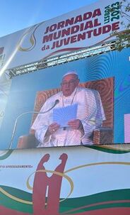 Large TV screen shwoing Pope Francis