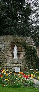 Garden grotto in Lourdes with Our Lady's statue