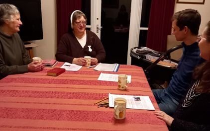 Sister a table talking with a RCIA group